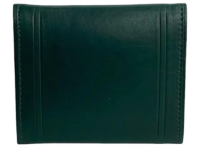 Monedero de cuero con monograma de Yves Saint Laurent. Monedero de cuero en excelente estado. Verde 