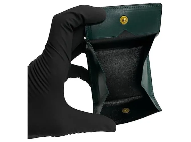 Monedero de cuero con monograma de Yves Saint Laurent. Monedero de cuero en excelente estado. Verde 